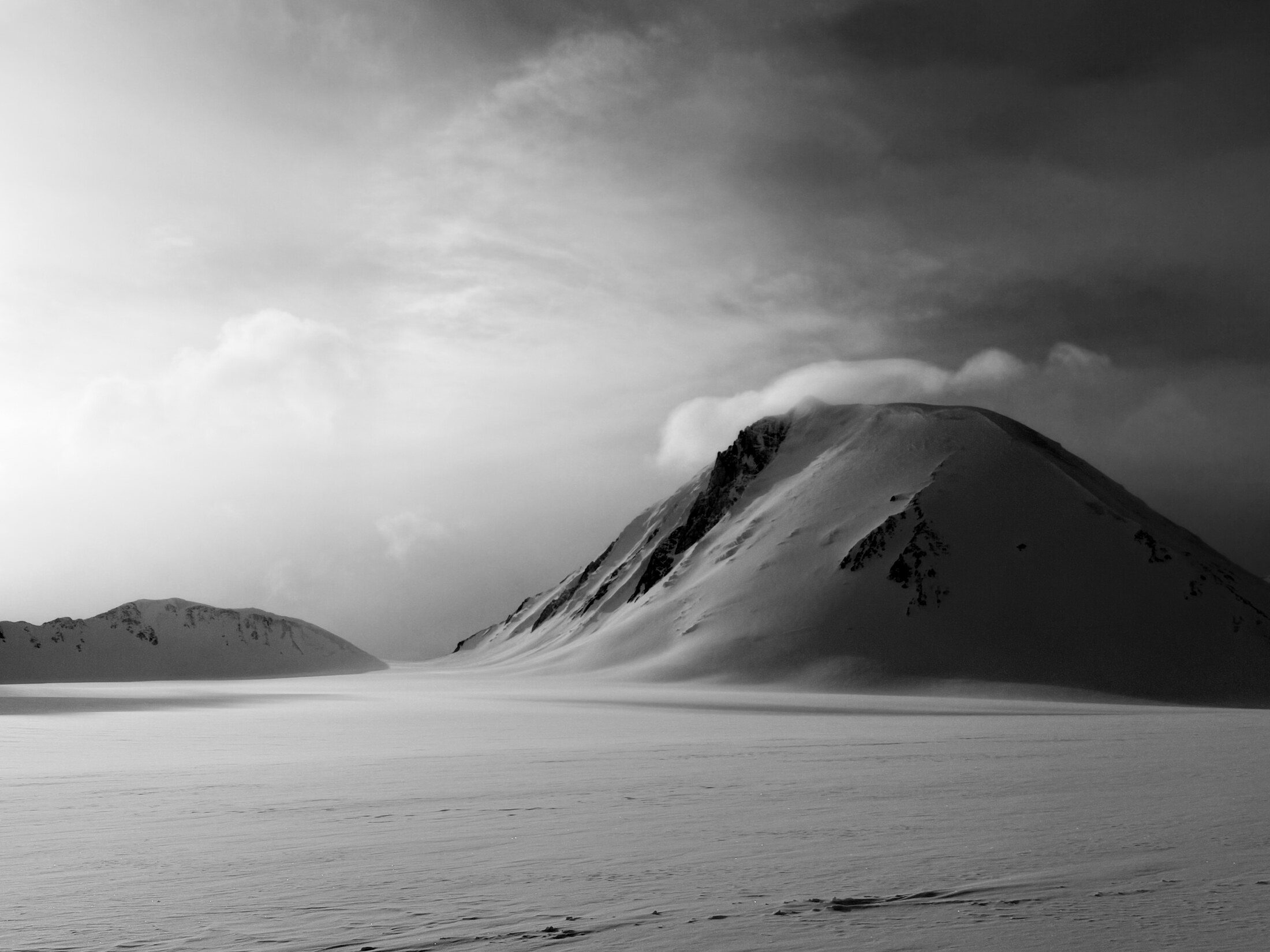 Clouds breaking over the snow-covered mountains of Eclipse Icefield